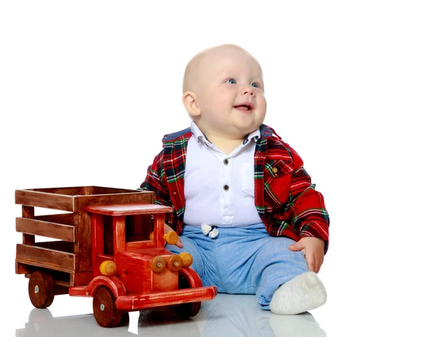 A little boy is playing with a toy car. — Stock Photo, Image