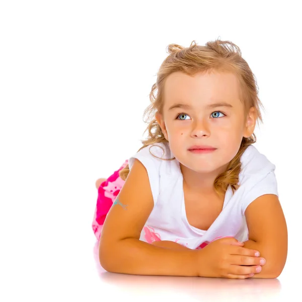 Little girl lies on the floor — Stock Photo, Image