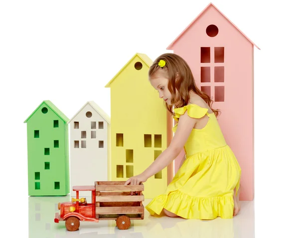 Маленька дівчинка грає з дерев'яною машиною . — стокове фото