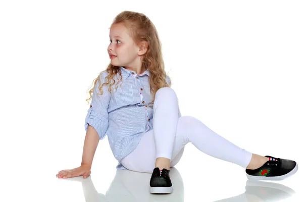 Little girl is sitting on the floor. — Stock Photo, Image