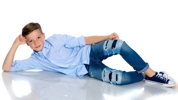 A teenager boy lies on a white background. — Stock Photo, Image