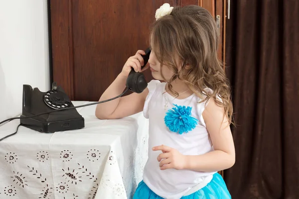 The girls ringing on the old phone. — Stock Photo, Image