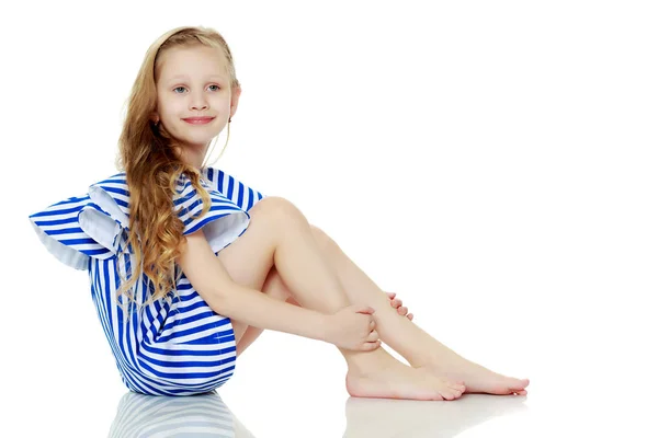 Adorable little blond girl in very short summer striped dress. — Stock Photo, Image