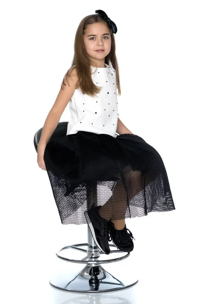 Little girl is sitting on a chair — Stock Photo, Image