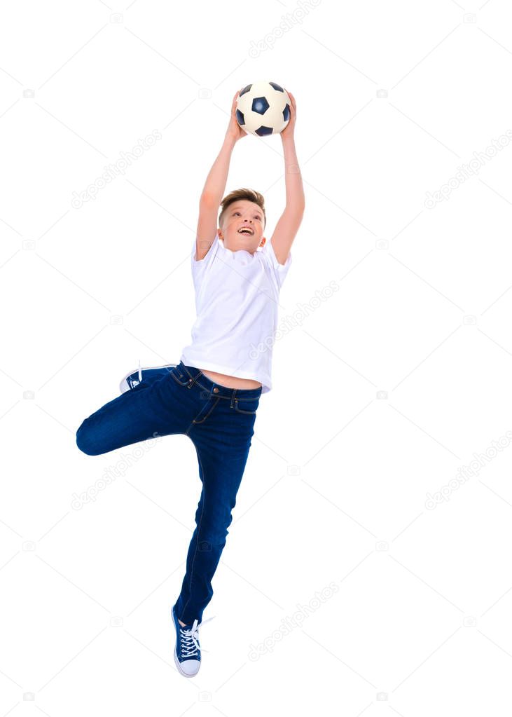 The little boy catches a soccer ball.