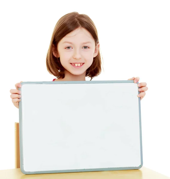 Little girl holding white poster. Royalty Free Stock Images