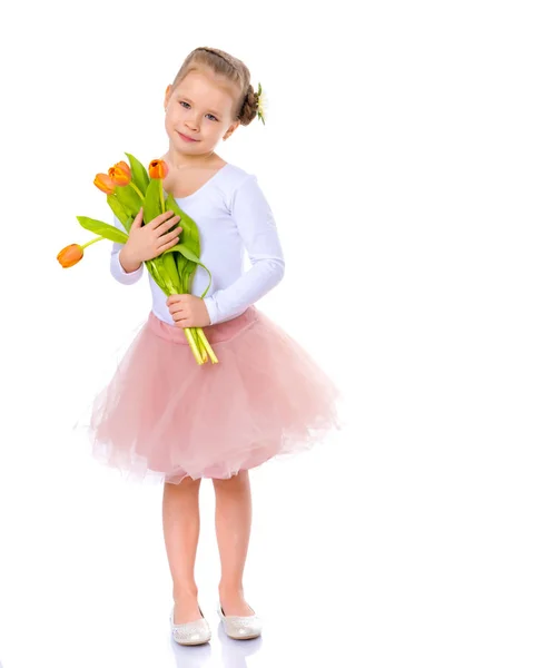 Little girl with a bouquet of tulips. — Stock Photo, Image