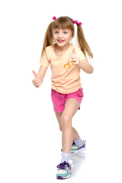 Niña sosteniendo su pulgar hacia arriba — Foto de Stock