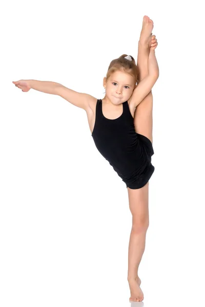 La gimnasta se equilibra en una pierna . — Foto de Stock