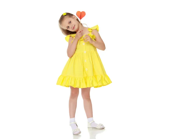 Menina com um doce em um pau — Fotografia de Stock