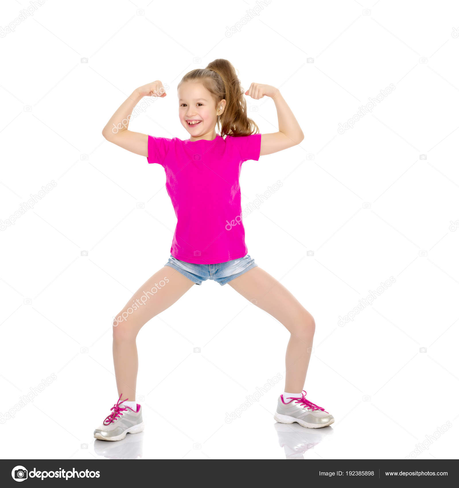 A little girl shows her muscles. — Stock Photo © lotosfoto1 #192385898