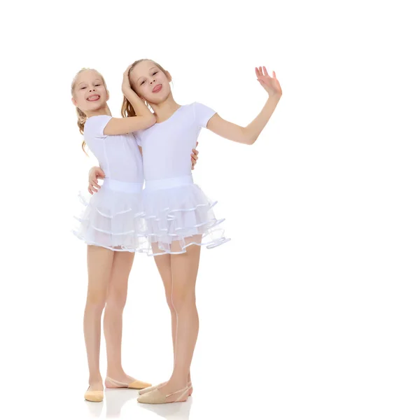 2 girls gymnast in white suits. — Stock Photo, Image