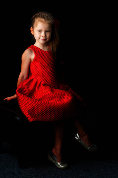Little girl on a black background