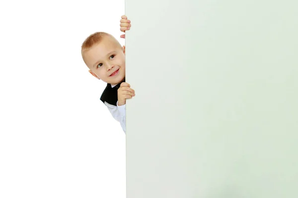 Boy peeks out from behind the banner Stock Image