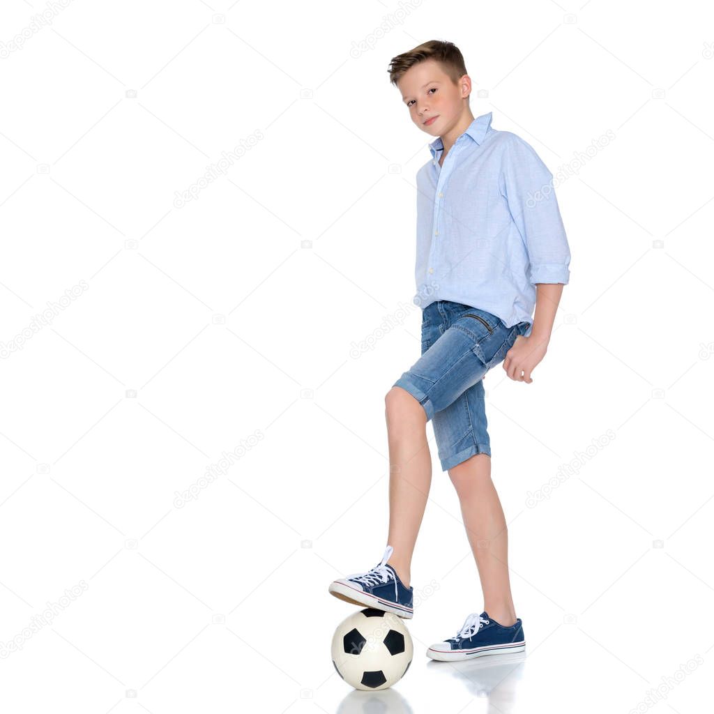 Boy teenager with a soccer ball.