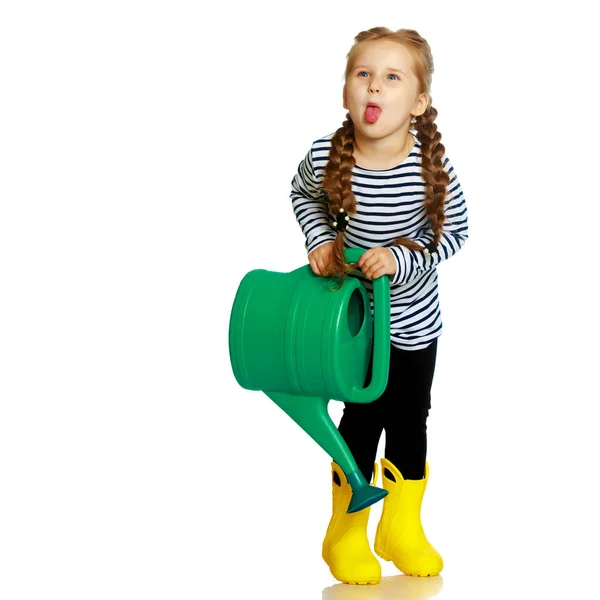 A little girl is watering a garden. — Stock Photo, Image