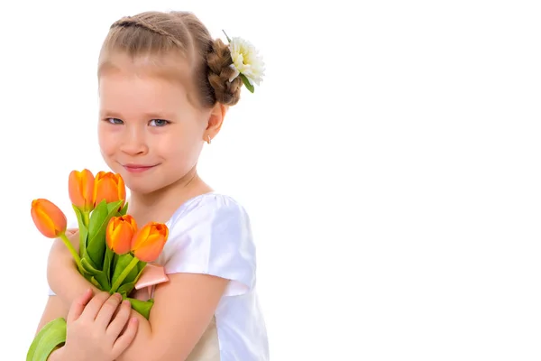Little girl with a bouquet of tulips. — Stock Photo, Image