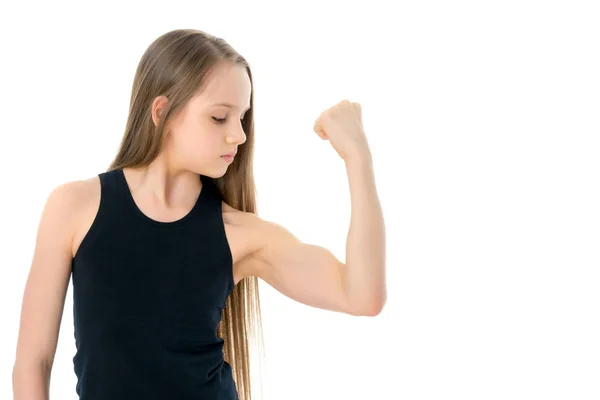 Una niña pequeña muestra sus músculos . — Foto de Stock