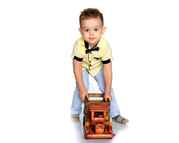 A little boy is playing with a toy car. — Stock Photo, Image