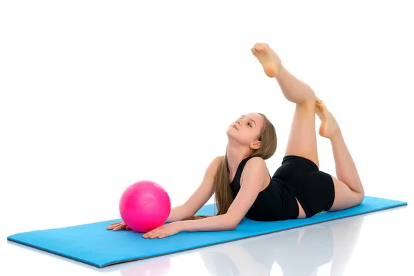 Little girl is engaged in fitness with a ball. — Stock Photo, Image