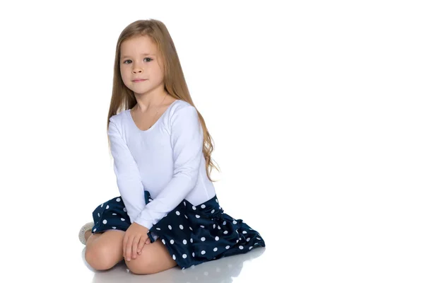 Little girl is sitting on the floor. — Stock Photo, Image