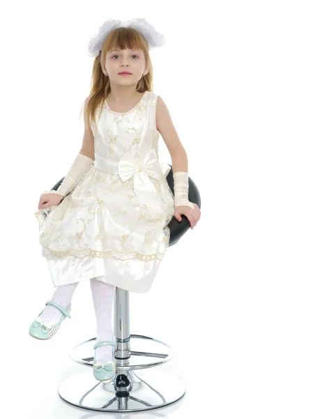 Little girl is sitting on a chair — Stock Photo, Image