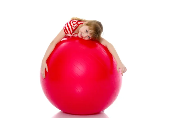 Niña haciendo ejercicios en una pelota grande para la aptitud. — Foto de Stock