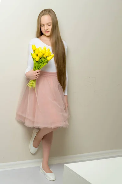Kleines Mädchen mit einem Strauß Tulpen. — Stockfoto