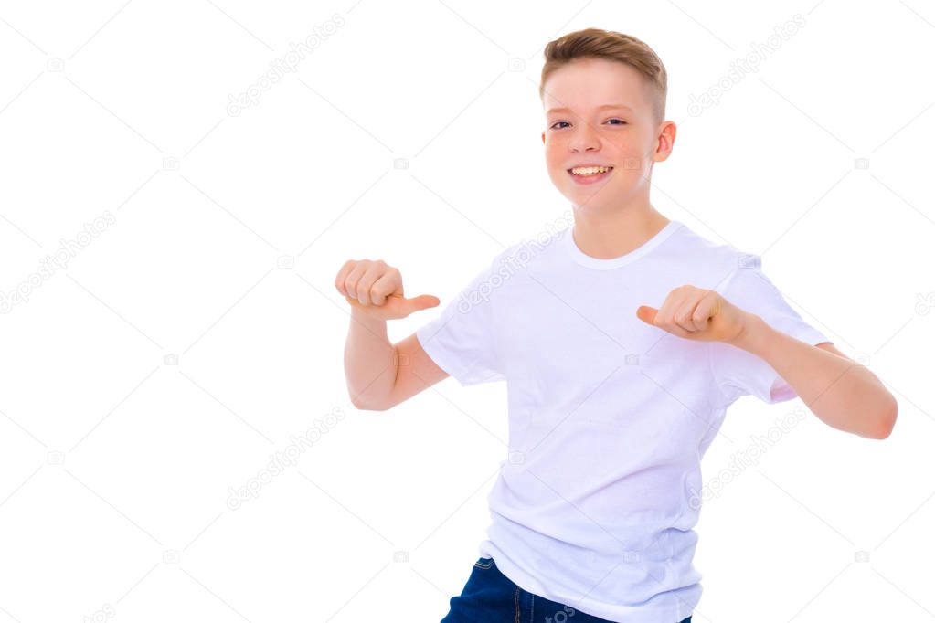 A school boy points to his white T-shirt.