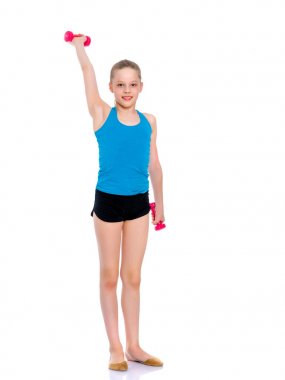 Küçük kız dambıllarla egzersiz yapıyor..