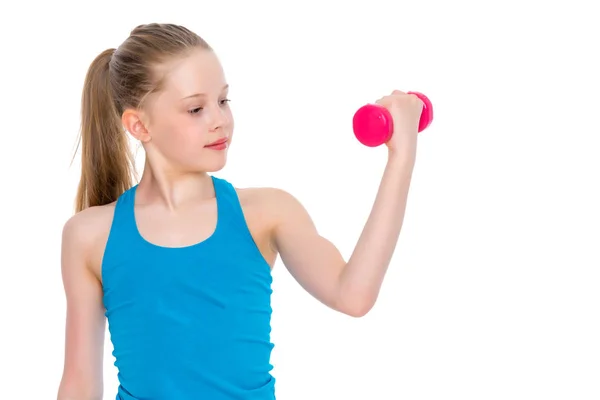 A little girl shows her muscles. — Stock Photo, Image