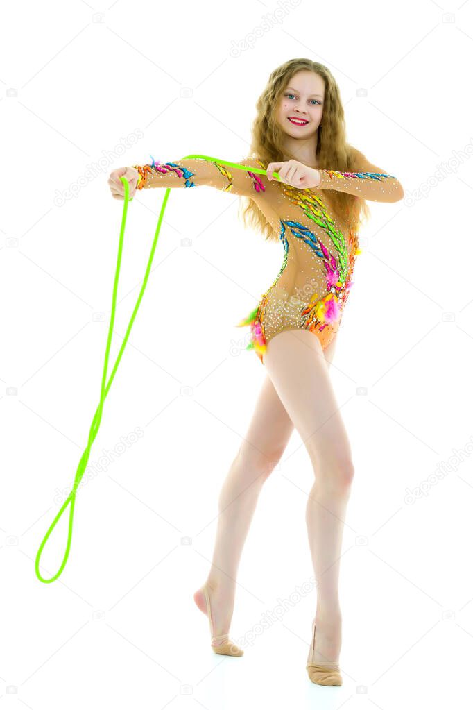 A girl gymnast performs exercises with a skipping rope.