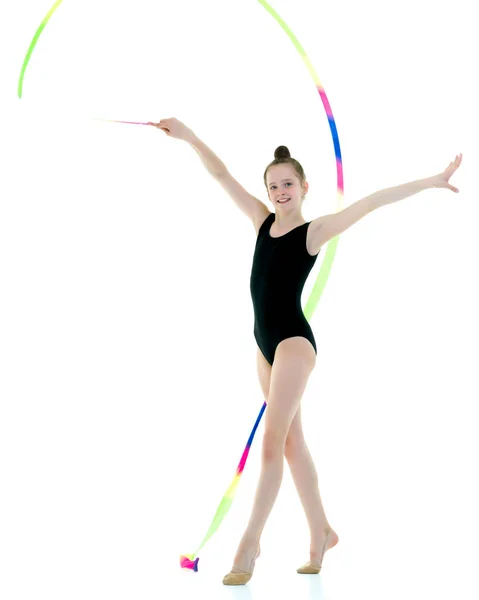 Girl gymnast performs exercises with tape. — Stock Photo, Image