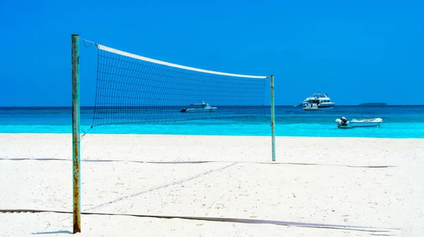 Volleyball net on a deserted sandy beach on the tropical sea. — Stock Photo, Image