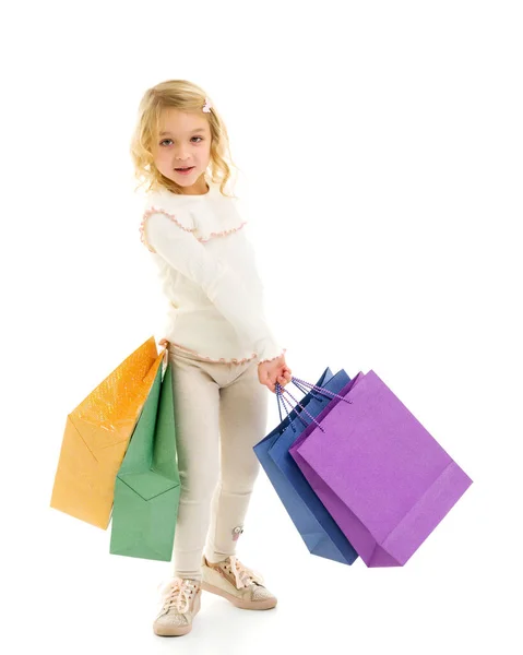 Little girl with multi-colored bags in their hands. — Stock Photo, Image