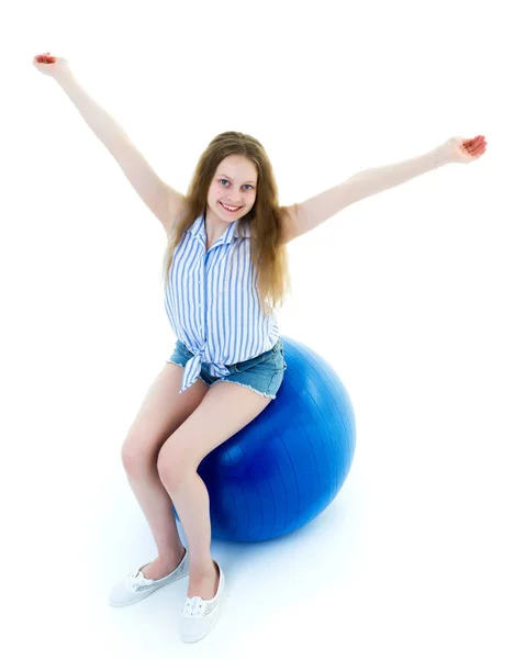 Niña haciendo ejercicios en una pelota grande para la aptitud. — Foto de Stock