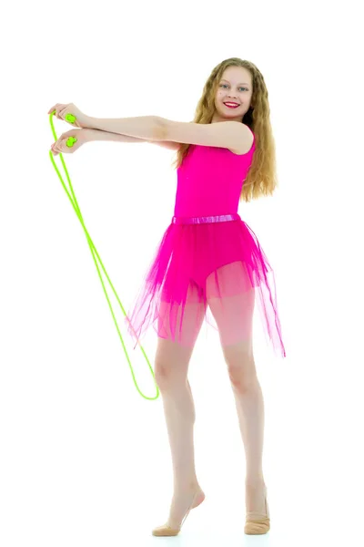 A girl gymnast performs exercises with a skipping rope. — Stock Photo, Image