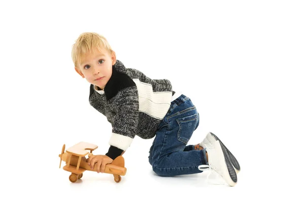 Little boy playing with wooden plane — Stock Photo, Image