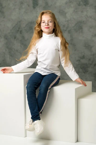 Beautiful little girl in big round glasses. — Stock Photo, Image