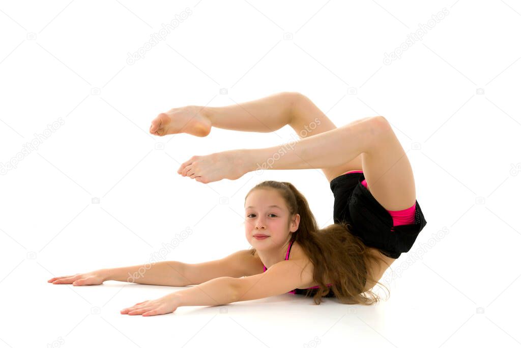 Gymnast Girl Lying on the Stomach Holding Up her Legs