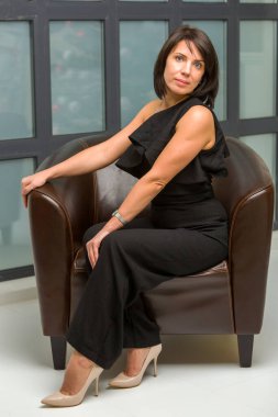 Akşamları, genç bir kadın kanepede oturur..