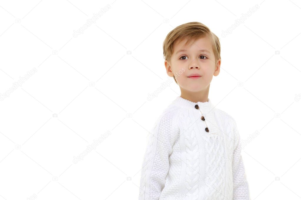 Handsome little boy in full growth on a white background. The concept of advertising, happy childhood.