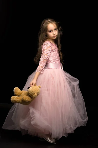 Menina encantadora em Nice vestido rosa olhando seriamente para a câmera — Fotografia de Stock