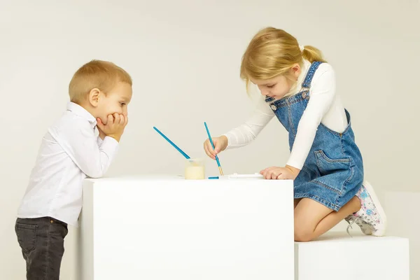 Blonde Girl Painting with Paintbrush, Her Brother Looking at Her — Stock Photo, Image