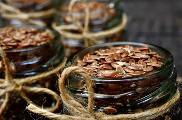 Flaxseed in jar on  table Stock Photo