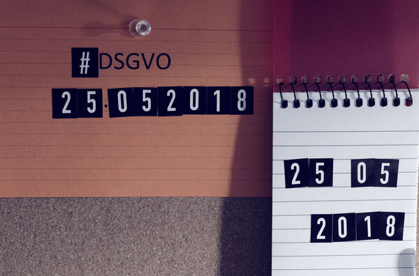 Board with the inscription Hashtag #DSGVO (General Data Protection Regulation) in English GDPR (General Data Protection Regulation) with a laptop and padlock for the introduction of the DSGVO in the EU on 25.05.2018