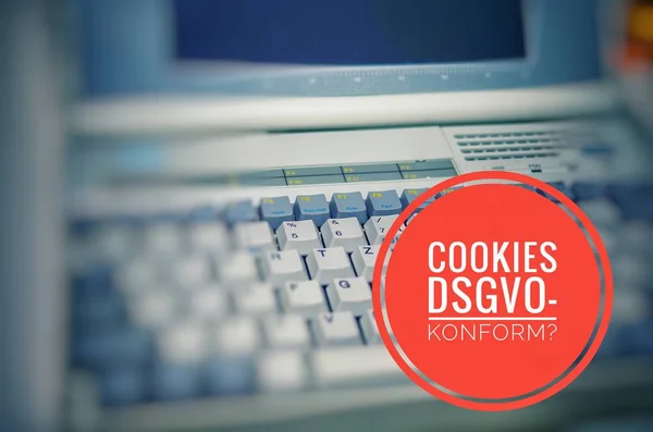 Old Laptop with inscription in german Cookies DSGVO-konform in english Cookies GDPR compliant to symbolize the General Data Protection Regulation in german Datenschutzgrundverordnung