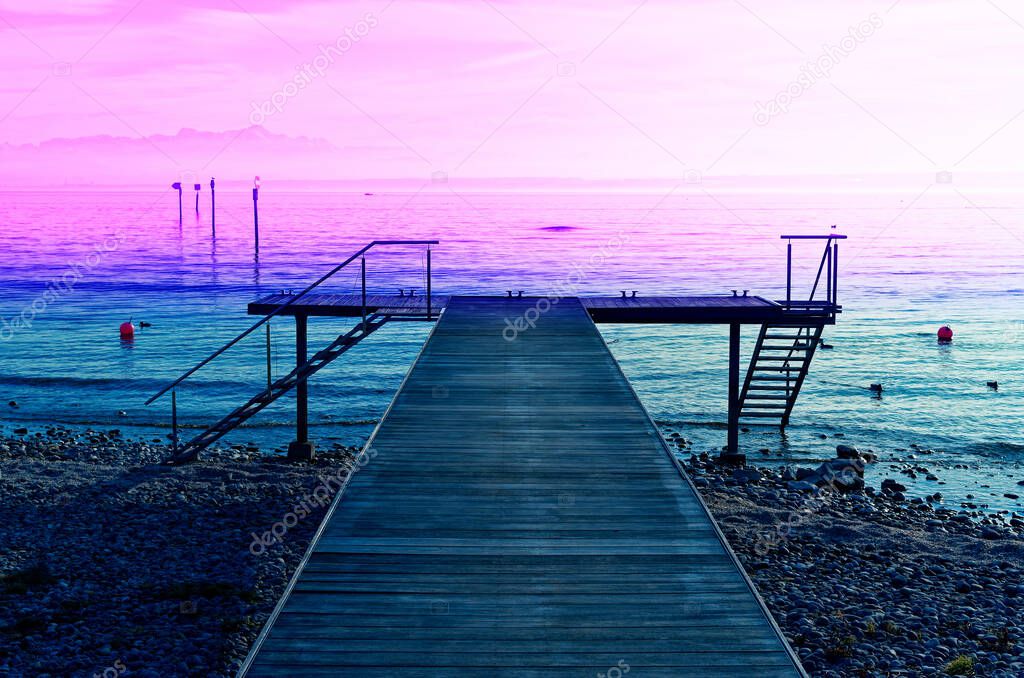 Boat dock on Lake Constance with a view of the Alps