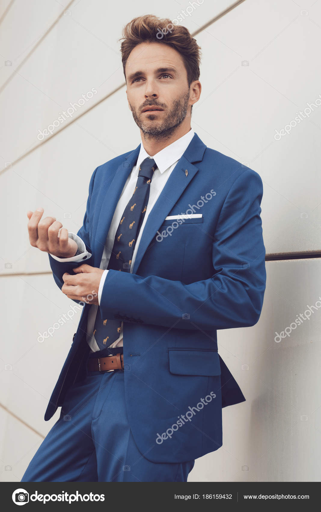Premium Photo | A man with a beard in a blue suit poses on the street to  advertise men's clothing.