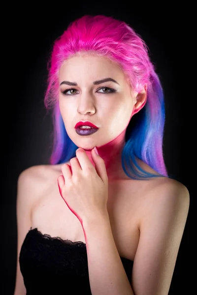 Portrait of attractive young woman with painted colorful hair. Half-lenght standing and touching face by hand. — Stock Photo, Image